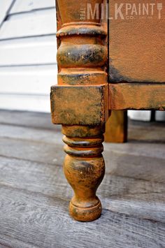 an old wooden chair with rusted paint on it