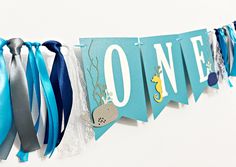 Looking for 1st Birthday decorations?! This eye-catching and awesome Ocean Theme ONE Banner is perfect to decorate the birthday baby's high chair or use as a photo prop, especially for cake smash pictures.  SIZE: Each flag measures 10.5 x 14.8 cm or 4.13" x 5.83" DETAILS: - Individually die-cut  - Made from high-quality cardstock - 250gsm - Satin ribbon trims on each side - OPTIONAL   Matching Confetti: https://www.etsy.com/listing/1046684533/200-pcs-under-the-sea-confetti-sea?click_key=146d5e4b Under The Sea Birthday Party Boy, One Der The Sea First Birthday, Oneder The Sea 1st Birthday Boy, Oneder The Sea Birthday, Costco Party, Under The Sea First Birthday, First Birthday Theme Boy, Baby Birthday Party Theme