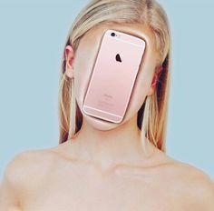 a woman holding an iphone up to her face