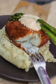 a plate topped with mashed potatoes and asparagus