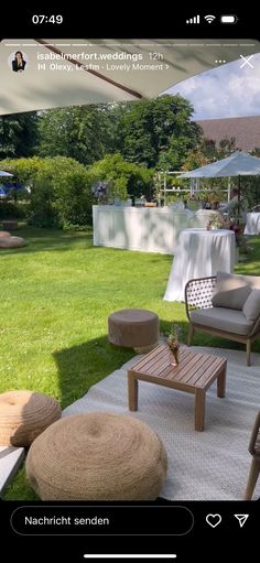 an outdoor patio with chairs and tables in the grass, next to a lawn area