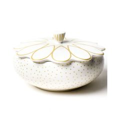 a white bowl with gold dots on it and a lid in the shape of a flower