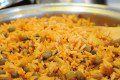 a pan filled with rice and peas on top of a table