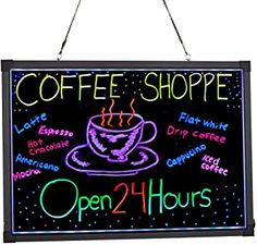 coffee shoppe open 24 hours sign hanging on the wall with black background and neon writing