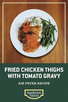 fried chicken thighs with tomato gravy and green beans on a white paper plate