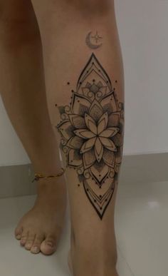 a woman's leg with a tattoo on it and a flower in the center