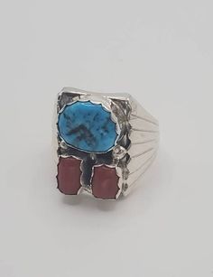 Turquoise and coral mens statement ring.  This sterling silver ring features a genuine turquoise stone and a red coral cab.  The dome design of this beautiful ring make it even more substantial.  The silver work is clean and concise and will definitely please any wearer.   This multi-stone ring would be be a fantastic Father's Day gift, gift for husband, gift for boyfriend, Christmas gift or anniversary gift.  It would also be great for the graduate or a birthday surprise for that special someone! Please check out the other listings in my Etsy shop to find necklaces, rings, bracelets and earrings that will be sure to please.