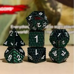 the green and white dices are stacked on top of each other, with numbers printed on them