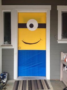 a yellow and blue door with a smiling face on it's front porch area