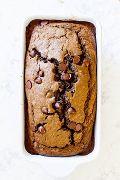 a loaf of chocolate chip bread in a white dish