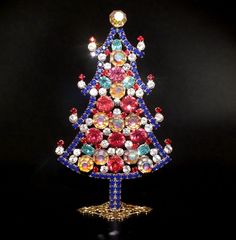 a brightly colored christmas tree made out of beads