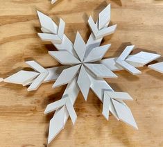 an origami snowflake sitting on top of a wooden table