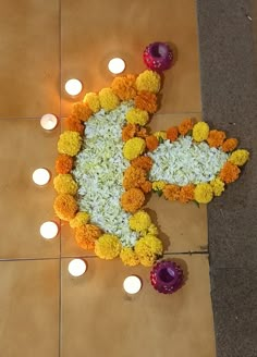 flowers and candles are arranged on the floor