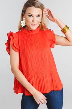 Red Flutter Sleeve Blouse For Summer, Casual Red Blouse With Flutter Sleeves, Chic Red Flowy Blouse, Red Spring Tops With Smocked Cuffs, Red Ruffle Sleeve Blouse For Summer, Chic Flowy Red Blouse, Spring Red Smocked Top With Ruffles, Trendy Red Ruffled Blouse, Orange Short Sleeve Blouse With Ruffles