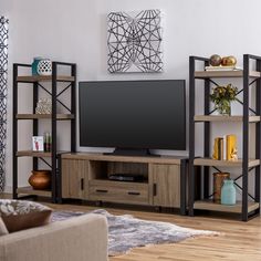 a living room filled with furniture and a flat screen tv on top of a wooden shelf