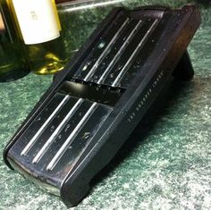 a bottle of wine sitting on top of a counter next to a cell phone case