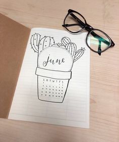 an open notebook with a cactus plant and glasses on it next to a pair of eyeglasses