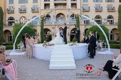 a bride and groom standing in front of an outdoor ceremony