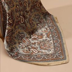 a close up of a paisley pattern on a table cloth