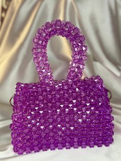 The model of the bag SPARK is made of multifaceted shimmering beads. This handmade bag is made of acrylic beads with a diameter of 10mm. The bag is perfect for evening looks or everyday wear.  It will become a bright accent in any of your looks and will collect many compliments. Handmade beaded handbag Material: acrylic Base to top of handle: 20cm Width: 5cm Height: 16cm Included with the bag is a metal chain of 1 m Bag with magnetic closure Today, beaded bags remain a symbol of wealth and elega Beaded Top Handle Bag For Shopping, Elegant Beaded Purple Shoulder Bag, Crystal Beads Bag, Luxury Beaded Square Bags, Glamorous Pearl-embellished Evening Bag, Wedding Guest Bags, Bridal Party Bags, Beaded Clutch Purse, Wool Bags