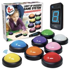 the electronic game is set up in front of its box and includes eight different colored buttons