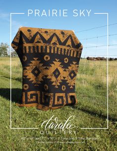 a blanket sitting on top of a lush green field