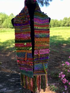 a multicolored scarf hanging from a tree