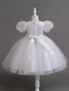 A touch of sweetness and a whole lot of elegance are in this beaded puff sleeve Communion dress. Designed to make special occasions even more magical with its glittering details and gorgeous beadwork, it's the ultimate twirl-worthy delight for your angel. Fluffy layers of lightweight fabric add a playful bounce to her moves, making each step extra charming. Sophisticated details elevate her look, ensuring a magical memory in the making. Perfect for Communion Day, weddings, pageants, birthday parties, dances, and other celebrations Puff sleeve tulle Communion dress with sequin details and beadwork waist accent Available in sizes 4T-12Y for toddlers and little girls White Dresses For Kids, Fluffy Layers, Kids White Dress, Day Weddings, Lightweight Fabric, Kids Dress, Bead Work, Puff Sleeve, Birthday Parties