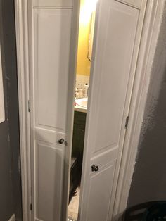 an open door leading to a bathroom sink