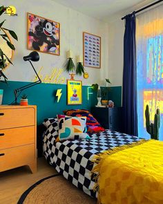 a bedroom with blue walls and yellow curtains, checkered bedspread on the bed