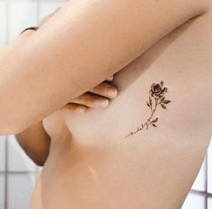 a woman with a rose tattoo on her chest