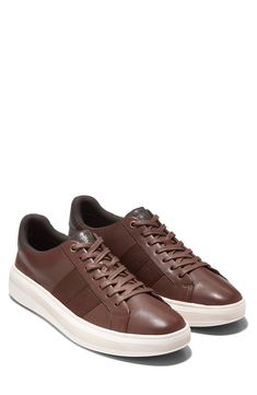 This sporty and stylish sneaker is a comfortable footwear staple you'll want to wear with every outfit. Cushioned insole White sole Leather upper/textile and leather lining/rubber sole Imported Brown Textile Sneakers With Contrast Sole, Brown Cushioned Sneakers For Light Sports, Brown Textile Sneakers With Rubber Sole, Brown Low-top Sneakers With Ortholite Insole, Comfortable Brown Sneakers With Ortholite Insole, Comfortable Brown Textile Sneakers, Comfortable Brown Sneakers With Cushioned Footbed, Comfortable Brown Sneakers With Textured Sole, Comfortable Brown Sneakers With Perforated Toe Box