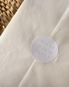 a piece of paper with the words wilde house paper on it sitting next to a wicker basket