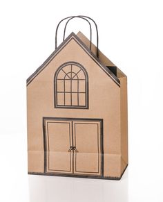 a brown paper bag with a small house on it's front door and windows