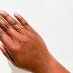 a woman's hand with two rings on it