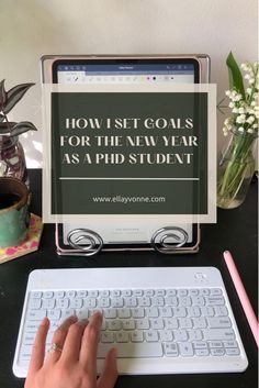 a person typing on a keyboard next to a monitor with the words how first goals for the new year as a pid student