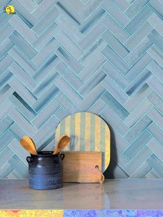 a wooden cutting board sitting on top of a counter next to a pot and spatula