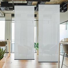 an office with two white privacy screens in the middle