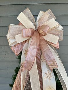 a christmas tree with pink and gold ribbons