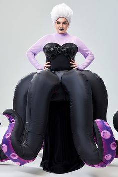 a woman is sitting on top of an inflatable octopus with her hands on her hips