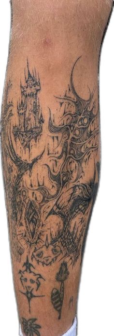 a man's leg with tattoos on it and an image of a castle in the background