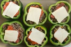 six stuffed peppers with cheese on top