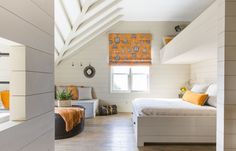 an attic bedroom with white walls and wood floors