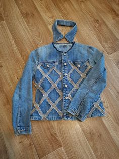 a denim jacket that is sitting on the floor