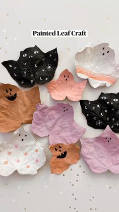 paper bats are arranged on a white surface with stars and sparkles around the edges