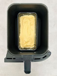 an ice cream in a black plastic container