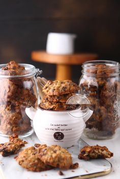 cookies in glass jars and spoons on a table