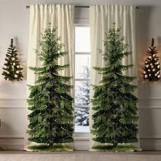 three christmas trees in front of a window