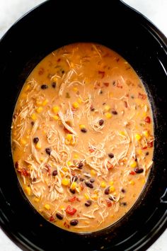 creamy chicken tortilla soup in a crock pot with corn and black beans