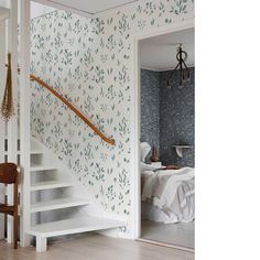 a room with stairs and wallpaper on the walls